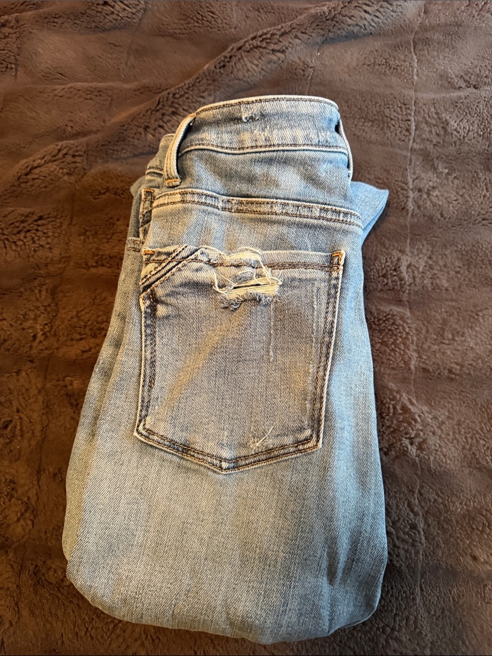 Buckle Light Blue Skinny Jeans with Distressed Back Pocket